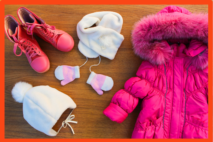 Photo of children's winter clothes including a coat, hat, scarf, gloves, and boots